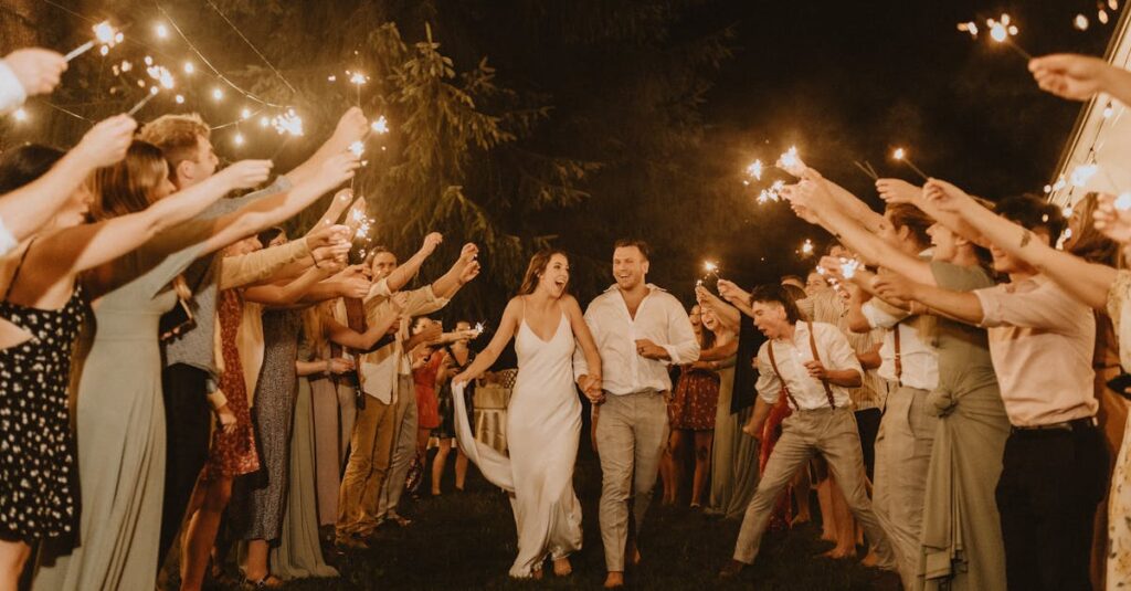 pexels-photo-30505264-30505264 Bride and groom joyfully exit surrounded by sparkling celebratory guests at a nighttime wedding.